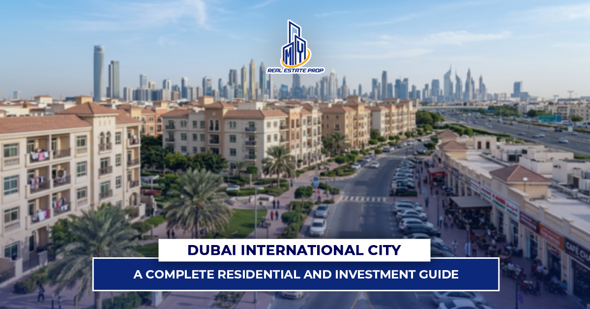 Dubai International City residential community with low-rise apartments, roads, and Dubai skyline in the background